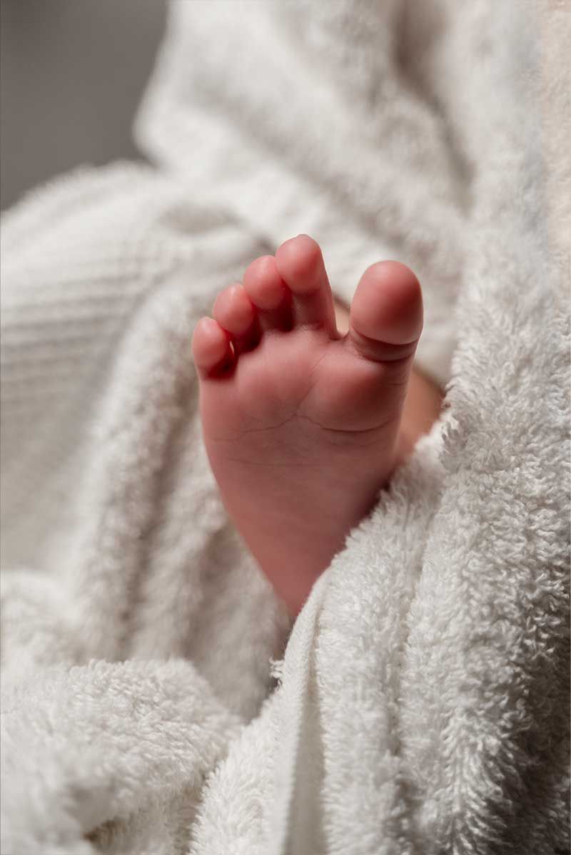 Baby feet wrapped in soft blanket